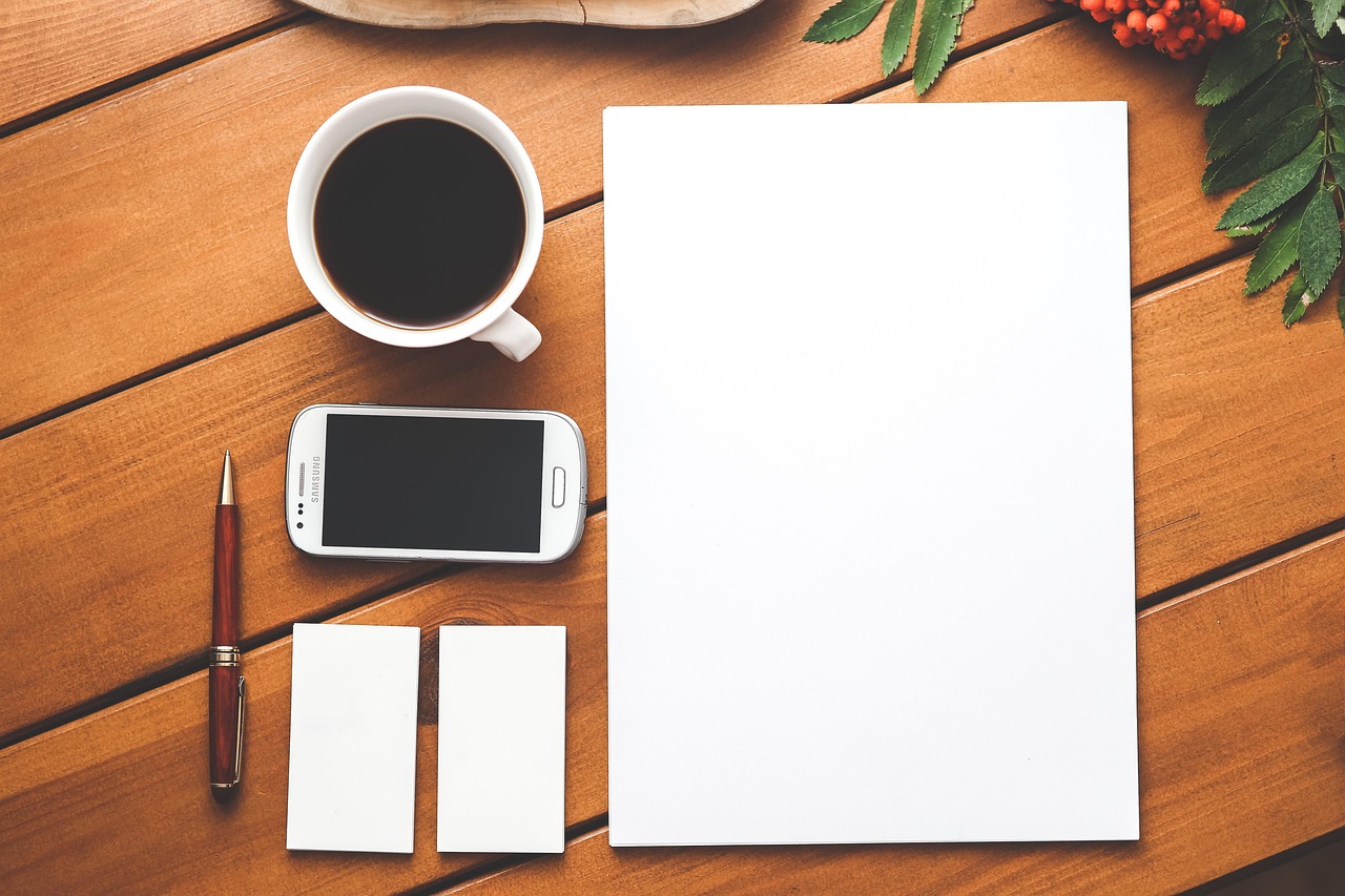 Coffee, phone, paper — Navigating the Waters of IronFX: A Comprehensive Review